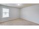 Cozy bedroom with neutral carpet, a window with blinds and neutral walls at 2045 Villa Spring Ct, Dacula, GA 30019