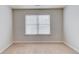 Bright bedroom with neutral carpet, a window with blinds and neutral walls at 2045 Villa Spring Ct, Dacula, GA 30019