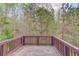 Wooden deck overlooking lush, mature trees and backyard landscape at 2045 Villa Spring Ct, Dacula, GA 30019