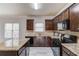 Open kitchen with granite counters, wood cabinets and stainless appliances at 2045 Villa Spring Ct, Dacula, GA 30019