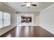 Open-concept living room featuring hardwood floors and view of a kitchen at 2045 Villa Spring Ct, Dacula, GA 30019