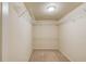 Spacious walk-in closet offering ample storage with multiple shelving units, carpeted floor and neutral paint at 2045 Villa Spring Ct, Dacula, GA 30019