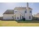 Back exterior featuring siding, a chimney, and a small patio area at 2470 Cordillo Dr, Dacula, GA 30019