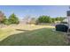 Picture of backyard with lawn, trees, and partially covered outdoor grill at 2470 Cordillo Dr, Dacula, GA 30019