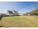 Large backyard featuring a green lawn, a wooden fence, and a view of the house at 2470 Cordillo Dr, Dacula, GA 30019