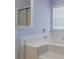 Bathroom featuring a whirlpool tub and window with blinds at 2470 Cordillo Dr, Dacula, GA 30019