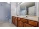 Bathroom with double vanity, wood cabinets, and blue walls at 2470 Cordillo Dr, Dacula, GA 30019