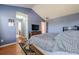 Bright primary bedroom with a vaulted ceiling, an ensuite bathroom, and a large bed at 2470 Cordillo Dr, Dacula, GA 30019