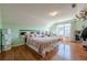 Bedroom with sloped ceilings, hardwood floors, and mint-green walls at 2470 Cordillo Dr, Dacula, GA 30019