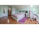 Bedroom featuring hardwood floors, sloped ceilings, and mint-green walls at 2470 Cordillo Dr, Dacula, GA 30019