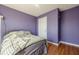 A bedroom with wood floors, a window with blinds, and purple walls at 2470 Cordillo Dr, Dacula, GA 30019