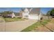 Spacious driveway leading to a two-story home with an attached garage, and a well-kept lawn at 2470 Cordillo Dr, Dacula, GA 30019