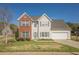 Inviting two-story home with a brick accent, a well-maintained lawn, and an attached garage at 2470 Cordillo Dr, Dacula, GA 30019