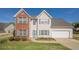 Charming two-story home featuring a well-maintained lawn and a two-car garage at 2470 Cordillo Dr, Dacula, GA 30019