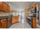 Open kitchen boasts stainless appliances, wood cabinets, and granite countertops at 2470 Cordillo Dr, Dacula, GA 30019