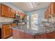 Kitchen features granite countertops, wood cabinets, stainless steel appliances, and tiled backsplash at 2470 Cordillo Dr, Dacula, GA 30019