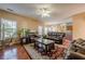 Cozy living room open to dining area features ceiling fan, hardwood floors, and leather furniture at 2470 Cordillo Dr, Dacula, GA 30019