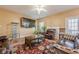 Comfortable living room features hardwood floors, ceiling fan, and dark brown leather couches at 2470 Cordillo Dr, Dacula, GA 30019