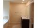 Bathroom featuring double sinks, granite counters, and a separate bathtub at 4265 Almanor Cir, Norcross, GA 30071