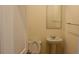 Small bathroom featuring pedestal sink and mirror with neutral walls at 4265 Almanor Cir, Norcross, GA 30071