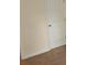 Clean bedroom view with a standard door, neutral carpeting, and light beige walls at 4265 Almanor Cir, Norcross, GA 30071