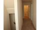 A hallway with carpeted floors, white walls, and doorways at 4265 Almanor Cir, Norcross, GA 30071