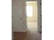 Hallway view leading to a carpeted bedroom featuring neutral walls and a bright window at 4265 Almanor Cir, Norcross, GA 30071