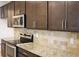The kitchen includes granite countertops, stainless steel appliances, and wooden cabinets at 4265 Almanor Cir, Norcross, GA 30071