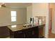 The kitchen island includes granite countertops and stainless steel appliances at 4265 Almanor Cir, Norcross, GA 30071