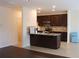 Modern kitchen with stainless steel appliances, dark cabinets, and granite countertops at 4265 Almanor Cir, Norcross, GA 30071
