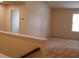 Open-concept living area with neutral carpet, natural light, and a staircase at 4265 Almanor Cir, Norcross, GA 30071