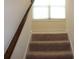 Carpeted staircase leading up to a window with blinds at 4265 Almanor Cir, Norcross, GA 30071