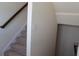 Carpeted staircase with a stained wooden handrail and white trim at 4265 Almanor Cir, Norcross, GA 30071