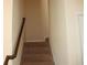 Carpeted staircase with wood railing leading to the upper level at 4265 Almanor Cir, Norcross, GA 30071