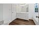 Bathroom featuring double vanity with white cabinets and laminate floors at 100 Chartres St, Dallas, GA 30157