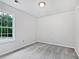The bedroom features a large window, neutral walls, and plush carpeting at 100 Chartres St, Dallas, GA 30157