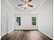 Bright bedroom with hardwood floors, tray ceilings, and a ceiling fan at 100 Chartres St, Dallas, GA 30157