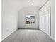 Bedroom with plush carpeting, closet, and a view of the outdoors at 100 Chartres St, Dallas, GA 30157