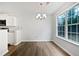 Dining room features a large window, light fixture, and hardwood floors at 100 Chartres St, Dallas, GA 30157