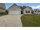 Charming single-Gathering home features a two-car garage, well-maintained lawn and driveway at 100 Chartres St, Dallas, GA 30157
