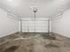 Spacious two-car garage with a white garage door at 100 Chartres St, Dallas, GA 30157