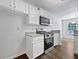 White kitchen cabinets complement the stainless steel range and granite counters at 100 Chartres St, Dallas, GA 30157