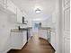Bright kitchen features white cabinets, stone countertops, and stainless steel appliances at 100 Chartres St, Dallas, GA 30157