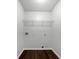 Clean, minimalist laundry room with wire shelf and white walls at 100 Chartres St, Dallas, GA 30157