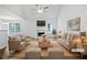 Bright living room featuring neutral paint, a fireplace, and large windows for natural light at 100 Chartres St, Dallas, GA 30157