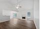 Spacious living room features neutral paint, large windows, fireplace, and hardwood floors at 100 Chartres St, Dallas, GA 30157