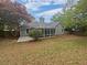 A backyard view of the home with a screened in porch at 2021 Emerald Dr, Loganville, GA 30052