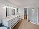 Bathroom features a double vanity, a standard toilet, and a tiled walk-in shower at 2021 Emerald Dr, Loganville, GA 30052