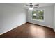 Simple bedroom with wood floors, ceiling fan and large window at 2021 Emerald Dr, Loganville, GA 30052