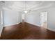 Large main bedroom with wood-look floors, large windows, ceiling fan and three entry doors at 2021 Emerald Dr, Loganville, GA 30052